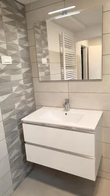 a bathroom with a white sink and a mirror at Sava river house - apartments in Bled