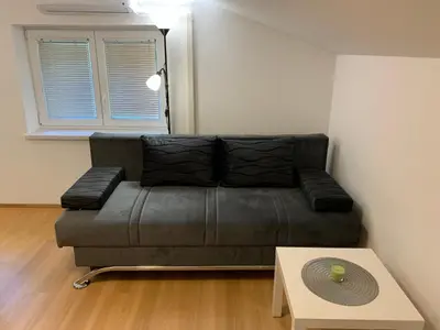 a leather couch in a living room with a table at Apartmaji Prʼ nas in Laško
