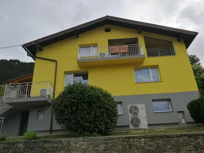 a yellow building with balconies on the side of it at Apartmaji Prʼ nas in Laško