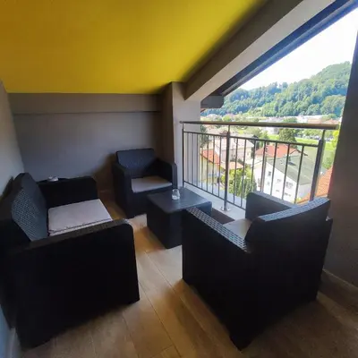a room with chairs and a balcony with a view at Apartmaji Prʼ nas in Laško