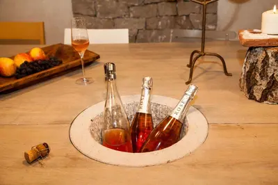 two bottles of champagne in a bowl on a table at MEGA in Prvačina