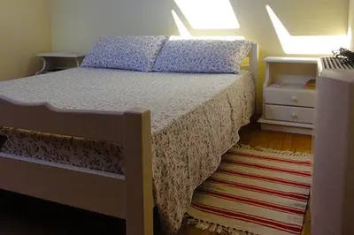 a bedroom with a bed and a dresser and a bed sidx sidx sidx sidx at Farmstay Kmetija Štekar in Kojsko