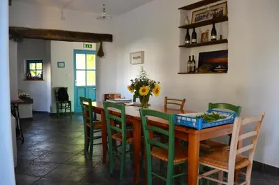 a dining room with a wooden table and chairs at Farmstay Kmetija Štekar in Kojsko