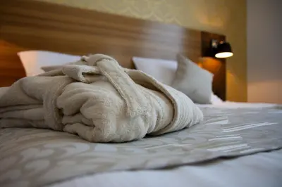 a towel sitting on top of a bed at Gold Club Hotel & Casino in Ajdovščina