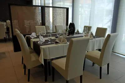 a dining room with a long table and chairs at Gold Club Hotel & Casino in Ajdovščina