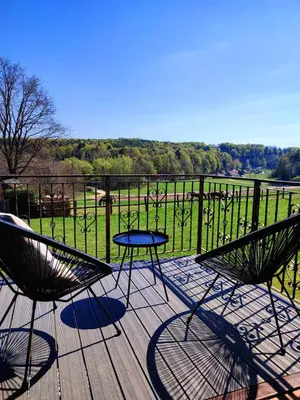 a patio with two chairs and a table on a deck at APARTMA KAPELSKI FANT in Sveti Jurij ob Ščavnici