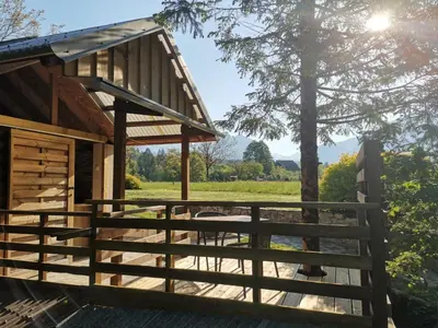 a cabin with a fence and a tree at Glamping Narnia in Bovec