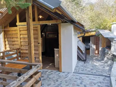a wooden building with a door and a porch at Glamping Narnia in Bovec
