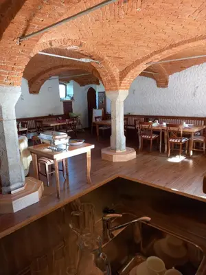 a restaurant with wooden tables and chairs in a room at B&B family room Tubej in Bohinj