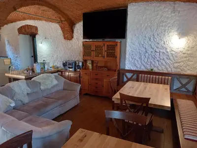 a living room with a couch and a table at B&B family room Tubej in Bohinj