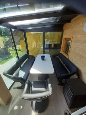 a room with a table and chairs in a train at SPA Tubej - Adults Only in Bohinj