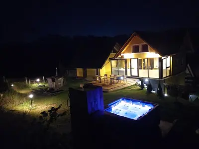 a house at night with a swimming pool in the yard at SPA Tubej - Adults Only in Bohinj