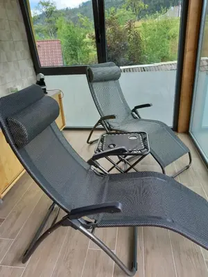 two chairs sitting in front of a window at SPA Tubej - Adults Only in Bohinj