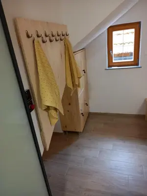 a hallway in a house with wooden doors and a window at SPA Tubej - Adults Only in Bohinj