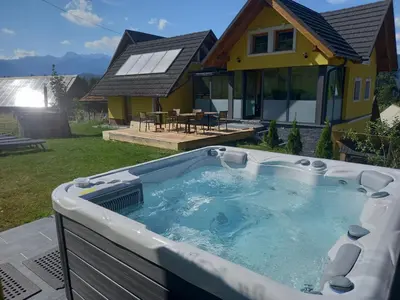 a hot tub in the backyard of a house at SPA Tubej - Adults Only in Bohinj