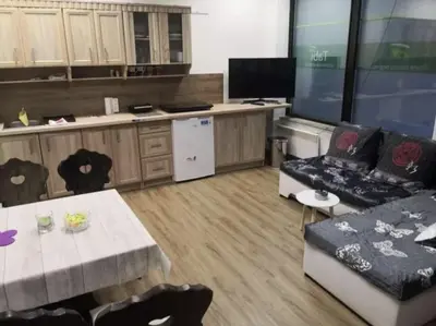 a room with a kitchen with a couch and a table at Apartman Alja, Kranjska Gora in Kranjska Gora
