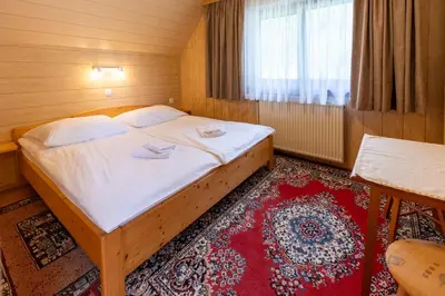a bed in a small room with a window at Apartma Boltar in Bohinj