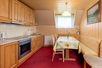 a kitchen with a table with a table cloth on it at Apartma Boltar in Bohinj