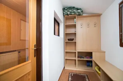 a room with a door and a closet with shelves at Apartma Boltar in Bohinj