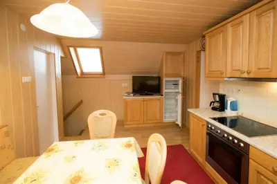 a small kitchen with a table and chairs in it at Apartma Boltar in Bohinj