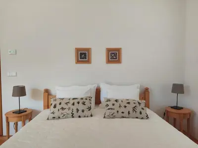 a bedroom with a bed with two lamps on two tables at Apartma Hiša 6 in Bohinj