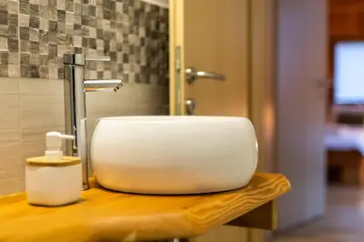 a white sink sitting on top of a counter at Apartmaji pri Dravi in Podvelka