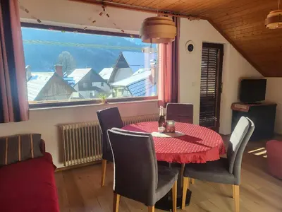 a dining room with a table and chairs and a window at APARTMA 27 in Kranjska Gora