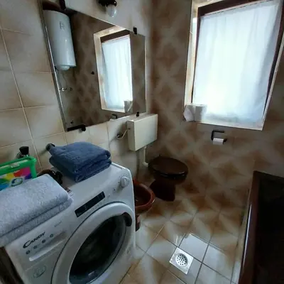 a washing machine in a bathroom with a mirror at APARTMA 27 in Kranjska Gora