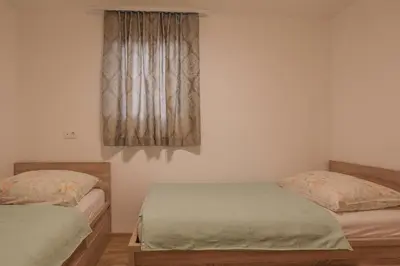 a bedroom with two twin beds and a window at Apartments Mulej in Bled
