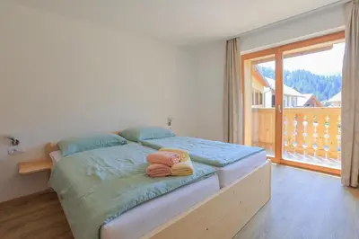 a bedroom with a bed with two towels on it at Apartments Mulej in Bled