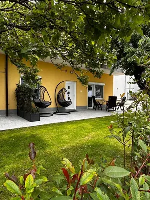 a house with two mirrors in a yard at RIAD Apartments Premium in Zgornje Škofije