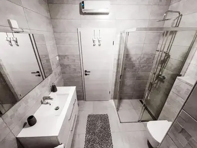 a bathroom with a shower and a sink and a mirror at RIAD Apartments Premium in Zgornje Škofije