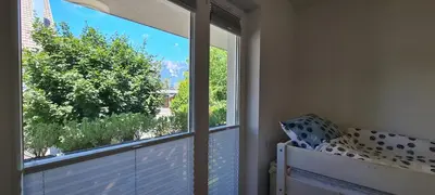 a room with a window with a bed and a view at Rozmarin Bled in Bled