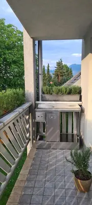 a kitchen on a patio with a balcony at Rozmarin Bled in Bled