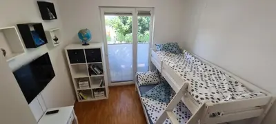 a small room with a bunk bed and a window at Rozmarin Bled in Bled