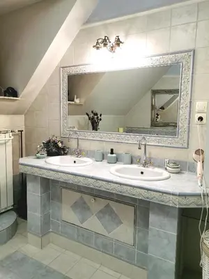a bathroom with two sinks and a large mirror at Apartmaji ARKO in Ribnica
