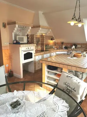 a kitchen with a glass table and a counter top at Apartmaji ARKO in Ribnica
