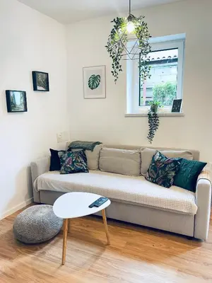 a living room with a couch and a table at Apartma Naty in Ljubljana