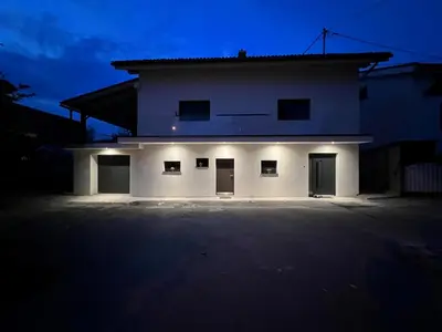 a large white house with a dark night at Apartma Naty in Ljubljana