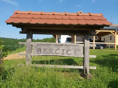 a sign in a field with a roof at Apartma Silvia in Metlika