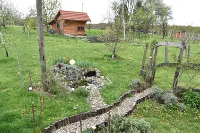 a garden with a stone path and a house at Apartma Silvia in Metlika