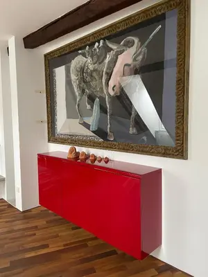 a red cabinet in a room with a painting on the wall at AB Ljubljana - Breg Apartments in Ljubljana