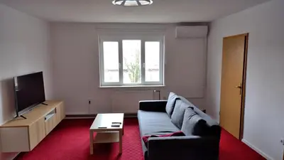a living room with a couch and a tv at Apartma VAL - Maribor in Maribor