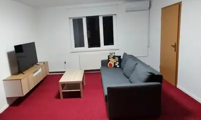 a living room with a couch and a tv at Apartma VAL - Maribor in Maribor