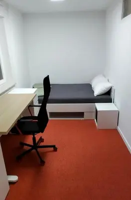 a room with a bed and a desk and a chair at Apartma VAL - Maribor in Maribor