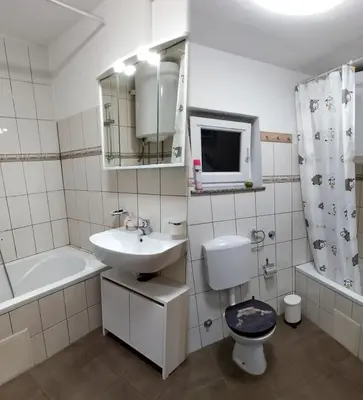 a bathroom with a sink and a toilet and a tub at Apartma VAL - Maribor in Maribor