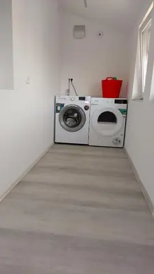 a washer and dryer in a white room at Apartma VAL - Maribor in Maribor