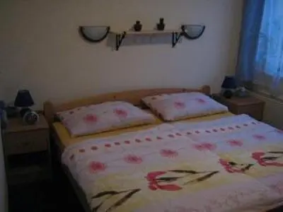 a bedroom with a bed with two pillows on it at Apartmaji Sparakel in Bled