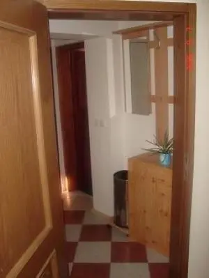 a hallway with a room with a checkered floor at Apartmaji Sparakel in Bled