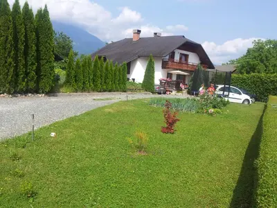 a house with a lawn in front of it at Apartmaji Sparakel in Bled
